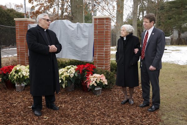 Father Michael Maffeo, Pastor, St. Edward The Confessor Church (Syosset NY), gives blessing and dedication of the Nicholas J. Bartilucci Administration Building with Mrs. Joan Bartilucci and Jericho Water District Superintendent, Peter Logan.