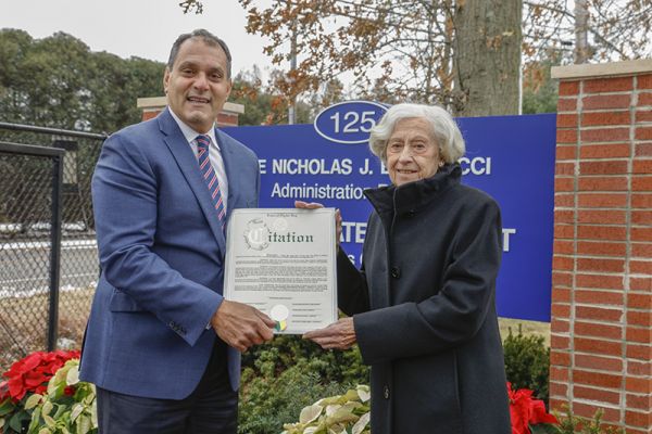 Joe Saladino, Supervisor of the Town of Oyster Bay presents a Citation to Mrs. Joan Bartilucci.